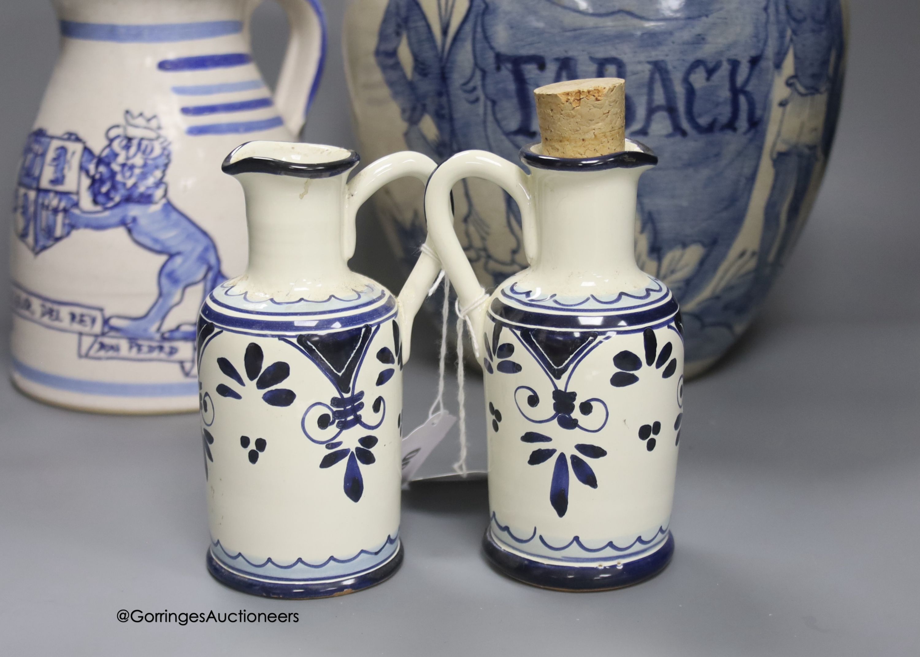 A tin-glazed terracotta barber's bowl dated 1819, a large ovoid eathenware ‘Taback’ jar and three earthenware jugs